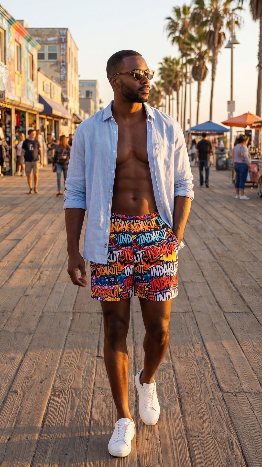 Indakut Everywhere men’s swim trunks with graffiti all over print worn on boardwalk in summer streetwear setting
